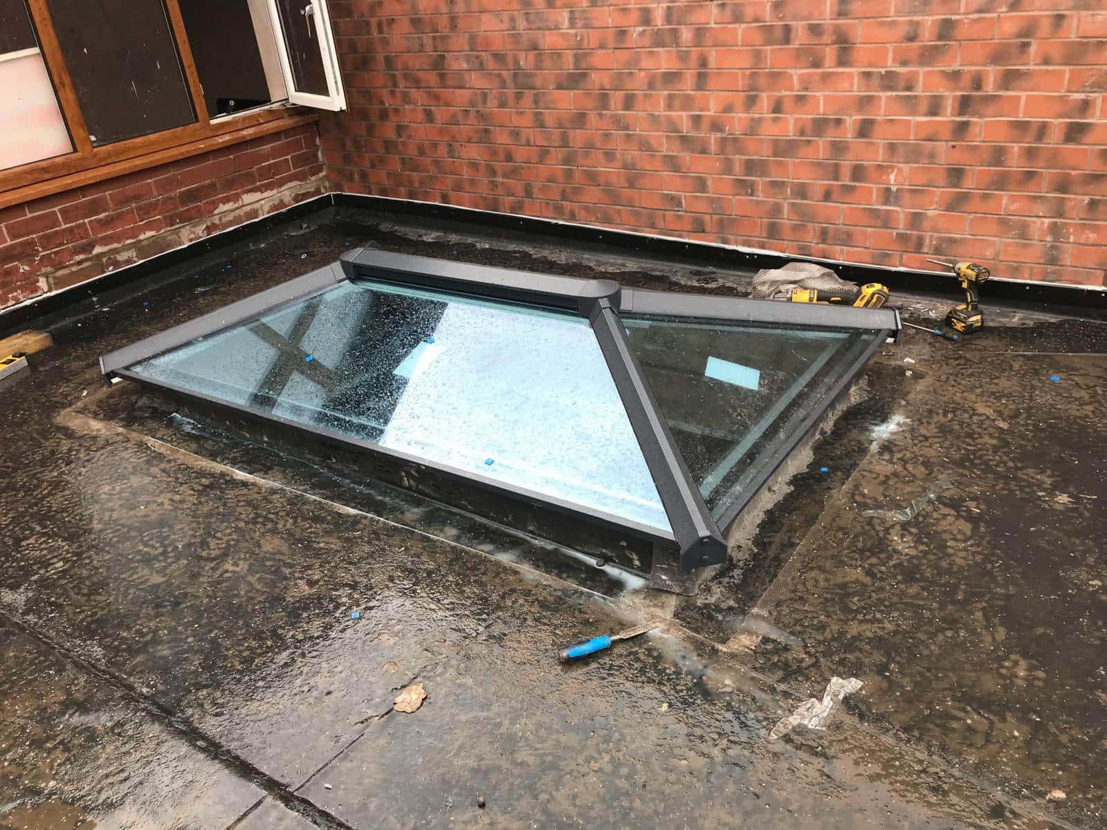 Glazed roof lantern on a flat roof, mid-installation.